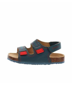Sandale ouverte pour enfants avec brides en cuir bleu foncé, accents en velcro rouge, semelle en liège rembourrée et bride de cheville ajustable.