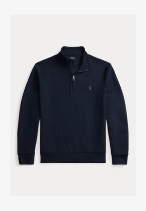 Mørkeblå fleece-pullover med høy krage, glidelås og brodert logo på brystet. Har lange ermer og ribbet hem.