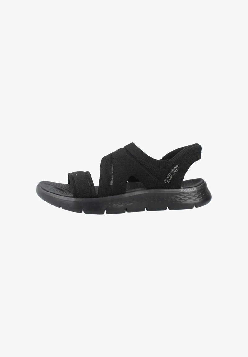 Black slip-on sandals with elastic straps, cushioned sole, and textured outsole. Simple design, suitable for casual wear.