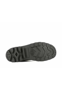 Suola di scarpa in gomma nera con modelli di grip testurizzati, inclusi battistrada profondi e una forma a diamante centrale. Marchio evidente visibile sulla suola.
