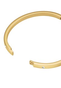 Gold-colored metal cuff bracelet with a smooth, rounded design, featuring a small clear gemstone accent near the opening.