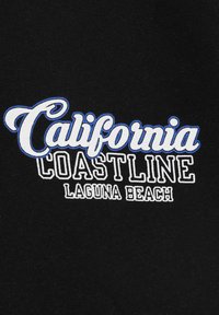 Black fabric with embroidered text: "California" in cursive blue, "COASTLINE" in bold white, and "LAGUNA BEACH" in smaller white letters below.