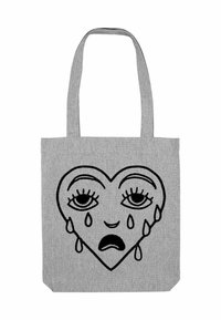 Borsa a tote in tessuto grigia con un design di cuore nero con occhi tristi e lacrime. La forma del cuore è centrale, contornata da linee spesse.