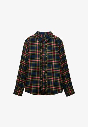 Tumši zils krekliņš ar rakstu, kurā ir zaļas, sarkanas un dzeltenas līnijas. Ripiņa priekšējā plāksnē un apkaklē. Garas piedurknes ar pogu aprocēm. Izgatavots no kokvilnas.