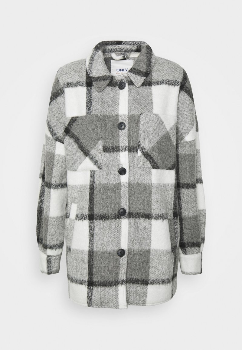 Camicia in flanella a quadri grigia e bianca con due tasche sul petto, bottoni neri e maniche lunghe. Tessuto morbido con una vestibilità rilassata.