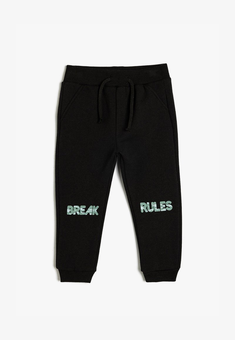 Pantalon de survêtement noir avec une taille à cordon de serrage, arborant "BREAK" et "RULES" en texte bleu clair sur chaque jambe. Fabriqué en tissu doux et texturé.