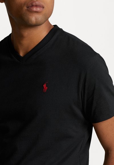 Black v-neck t-shirt made of cotton, featuring a small red embroidered logo on the left chest. Short sleeves and soft texture.