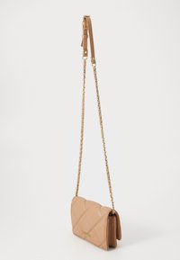 Light brown quilted leather crossbody bag with gold chain strap and adjustable leather section, gold brand logo on front flap.