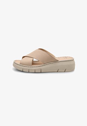 Mule beige avec un design à lanières croisées, tige en cuir lisse, semelle intérieure rembourrée et semelle de plate-forme légère et flexible.