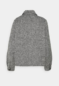 Černobíle vzorovaný kabát s límcovým krkem, knoflíkovými manžetami a boxy střihem. Látka má texturovaný, tkaný vzhled.