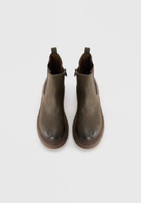 Brown leather ankle boots with a smooth finish, elastic side panels, and a sturdy rubber sole; two pull tabs at the rear for easy wear.