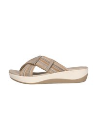 Beige platform-sandaalit, joissa on ristikkäisnauhadesign teksturoituvassa kankaassa. Niissä on vaaleanruskeita ja kermaisia vaakaraitoja sekä pehmustettu pohja.