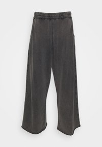 Weit geschnittene, dunkelgraue Sweatpants aus weichem Stoff; ausgestattet mit einem elastischen Bund, Seitentaschen und einer lockeren Silhouette.