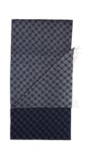Dark blue scarf with a patterned weave featuring hexagonal shapes, textured fabric, and fringed edges. Reversible to a solid dark shade.