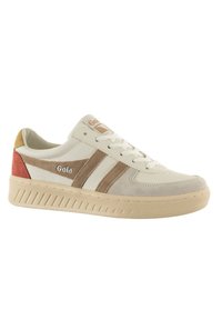 Sports sneaker in beige with tan and coral accents, featuring white laces, a textured upper, and a ribbed sole for traction.