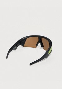 Sport sunglasses with a black plastic frame, brown tinted lenses, and a green accent on the arm. Aerodynamic design for active wear.