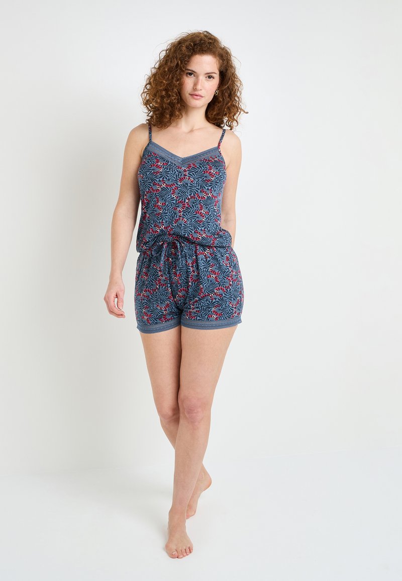 Combinaison à imprimé floral bleu avec bretelles ajustables, décolleté en V et taille élastique. Comprend des jambes courtes et une texture de tissu douce.