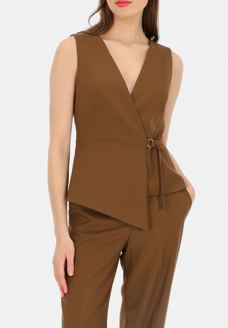 Brązowy bezrękawnik z głębokim dekoltem w serek, z asymetrycznym dołem, subtelną teksturą oraz bocznym wiązaniem z metalowym akcentem.