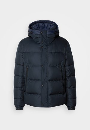Giacca puffy blu navy con cappuccio, design trapuntato, chiusura frontale con zip e bottoni a pressione, due tasche laterali e polsini elasticizzati.