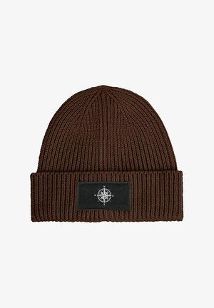 Brown knitted beanie with a folded cuff, featuring a black rectangular patch with a white compass design. Textured fabric with vertical ribbing.