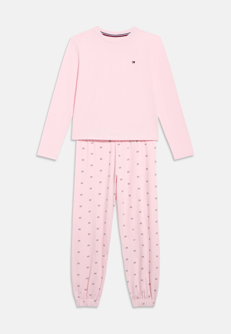 Svetloružová súprava s dlhým rukávom a nohavicami, nohavice s drobnými potlačami loga, elastické manžety na nohaviciach, jemné malé logo na ľavej hornej časti hrudníka.