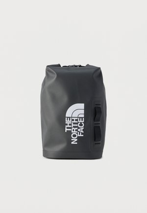 Black roll-top dry bag with white "The North Face" logo and two black carrying straps on the side, standing upright on a white background.