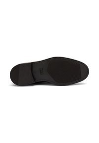 Sole di scarpa in pelle nera, con una texture liscia caratterizzata da un motivo antiscivolo in gomma e dettagli cuciti lungo il bordo, forma curvata all'apice.
