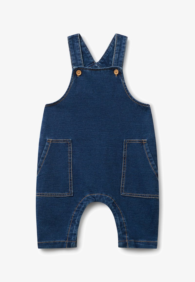 Denimowy kombinezon w ciemnoniebieskim kolorze z regulowanymi ramiączkami, dwiema przednimi kieszeniami i zaokrąglonym otworem nogawki. Posiada kontrastujące żółte szwy.