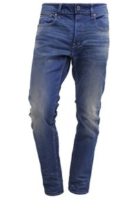 Mörkblå denimjeans med lättare blekningar, femficksdesign, dragkedjeflykt och bälteshällor. Rak passform med subtila sömnadsdetaljer.