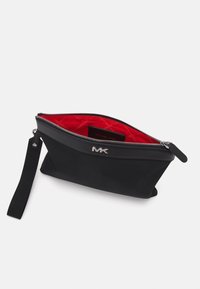 Black nylon clutch with a zip closure, featuring a red interior and an embossed silver logo. Includes a detachable black strap.