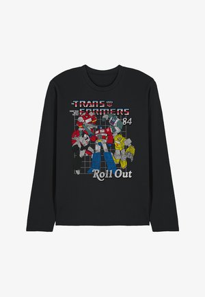 Black long-sleeve shirt featuring cartoon Transformers characters in red, blue, and yellow graphic print. Text reads "Roll Out" and "84."