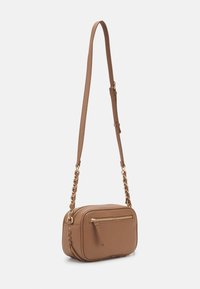 Borsa a tracolla color tan realizzata in materiale sintetico liscio, di forma rettangolare, con un dettaglio cucito sul lato e rifiniture in metallo dorato. Inclusa una tracolla regolabile.