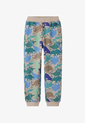 Pantalon de jogging en coton avec un imprimé multicolore de dinosaures en bleu, vert et marron. Conçu avec une taille élastique et des poignets.