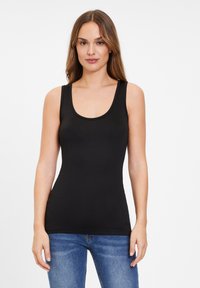 Black sleeveless tank top made of smooth fabric with a scooped neckline, fitted design, and a simple hem; paired with blue denim jeans.
