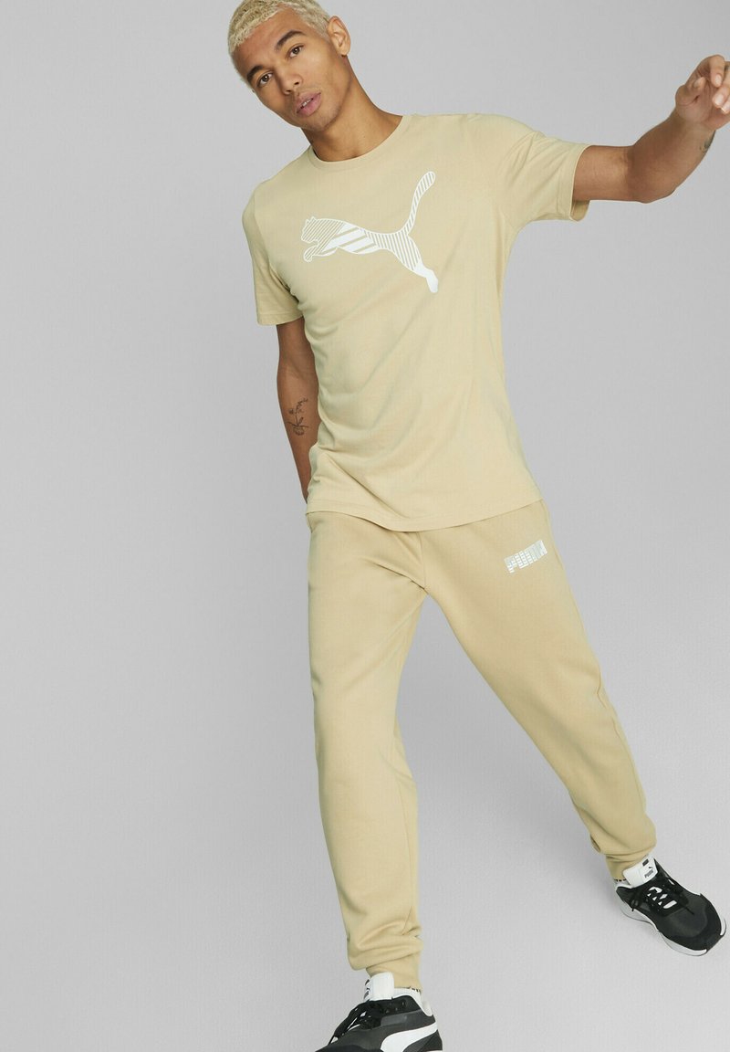 Puma Tracksuit bottoms light sand/beige Zalando