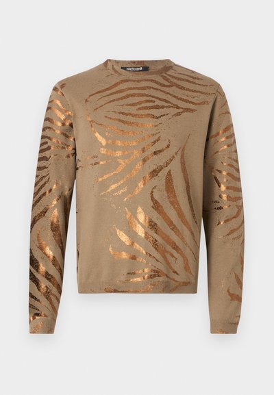 Beige sweater featuring metallic bronze zebra stripes, round neckline, and long sleeves with ribbed cuffs and hem. Soft knit texture.