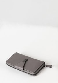 Gray leather wallet with textured finish, zip closure, and a contrasting smooth flap accent. Features black hardware and a minimalist design.