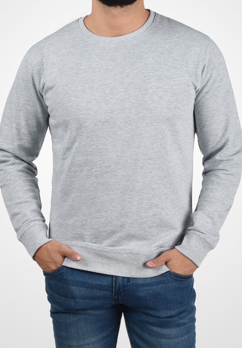 Grauer Pullover mit Rundhalsausschnitt, langen Ärmeln und gerippten Bündchen. Glatte Textur, entspannter Schnitt und Bund.