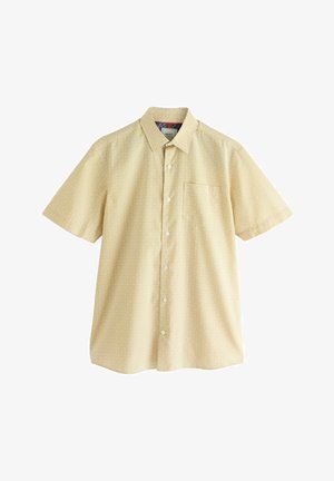 Krátky rukáv, žltá košeľa s diamantovým vzorom, zapínanie na gombíky a náprsného vrecka. Vyrobená z ľahkého materiálu.