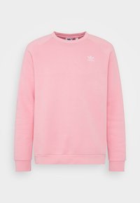 Vaaleanpunainen huppari pitkillä hihoilla, pyöreällä kaula-aukolla ja ribbauskantilla. Rinnassa valkoinen Adidas-logo. Tasainen rakenne.