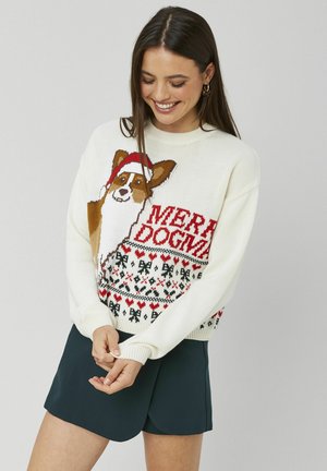 Pull en tricot blanc avec un Corgi portant un bonnet de Noël, le texte rouge "MERRY DOGMAS" et un motif festif de cœurs et de nœuds en noir et rouge.