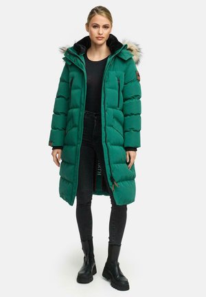 Green puffer coat with a fur-lined hood, zippered pockets, and a long silhouette, paired with black pants and chunky black boots.