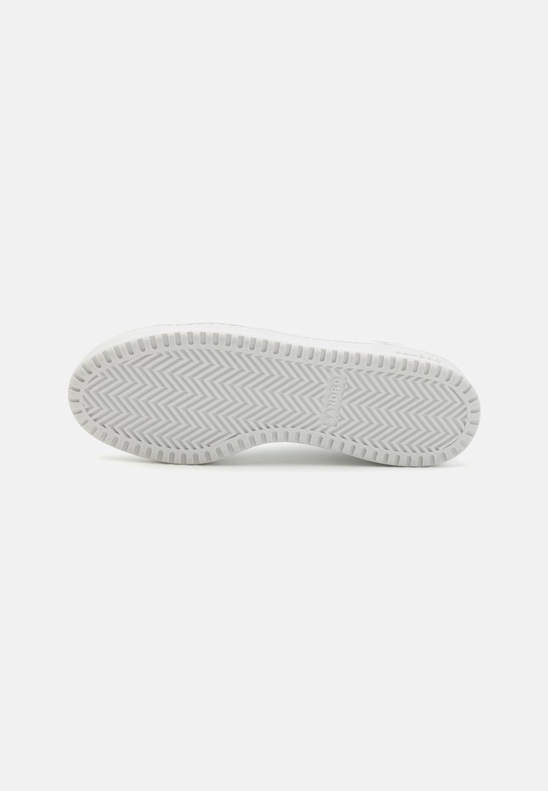 White sneaker sole with a herringbone pattern, featuring a smooth, rounded edge. Minimal branding visible on the side.