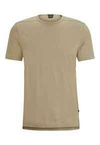 T-shirt in cotone color beige con collo rotondo, maniche corte e dettagli di cucitura sottili. Presenta un piccolo etichetta del logo sul lato inferiore.