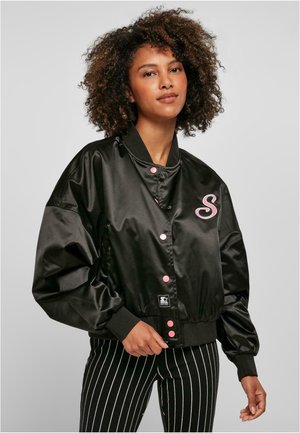 Black satin bomber jacket with pink snap buttons and an embroidered letter "S" on the chest. Features a ribbed collar and oversized sleeves.