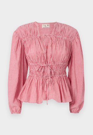 Bluzica s rdečimi in belimi črtami, dolgimi rokavi, nabranim zgornjim delom in nastavljivo vrvico v pasu, s peplum robom.