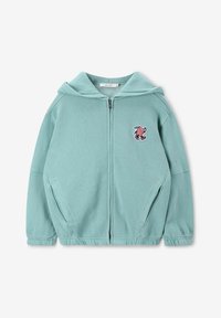 Haut à capuche zippé bleu clair avec une poche kangourou, des poignets côtelés et un détail de personnage brodé sur le côté gauche de la poitrine. Matière en coton doux.
