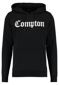Felpa nera realizzata in un mix di cotone, con tasca frontale e cappuccio regolabile con lacci. La scritta "Compton" è stampata in grande carattere gotico bianco sul petto.