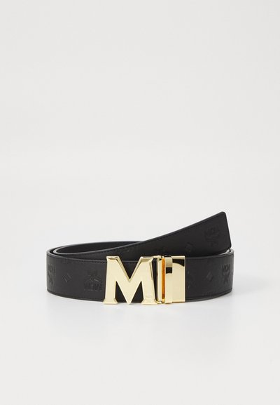 Schwarzer Leder Gürtel mit einer goldfarbenen Schnalle, die das "MCM"-Logo zeigt. Der Gürtel hat eine glatte Textur und ist mit einem dezenten Muster geprägt.
