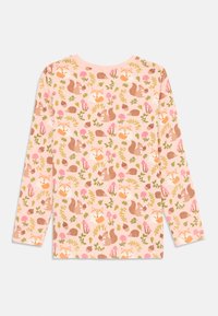 Long-sleeve shirt in soft pink fabric featuring a playful pattern of foxes, squirrels, mushrooms, and leaves in brown, orange, and green hues.